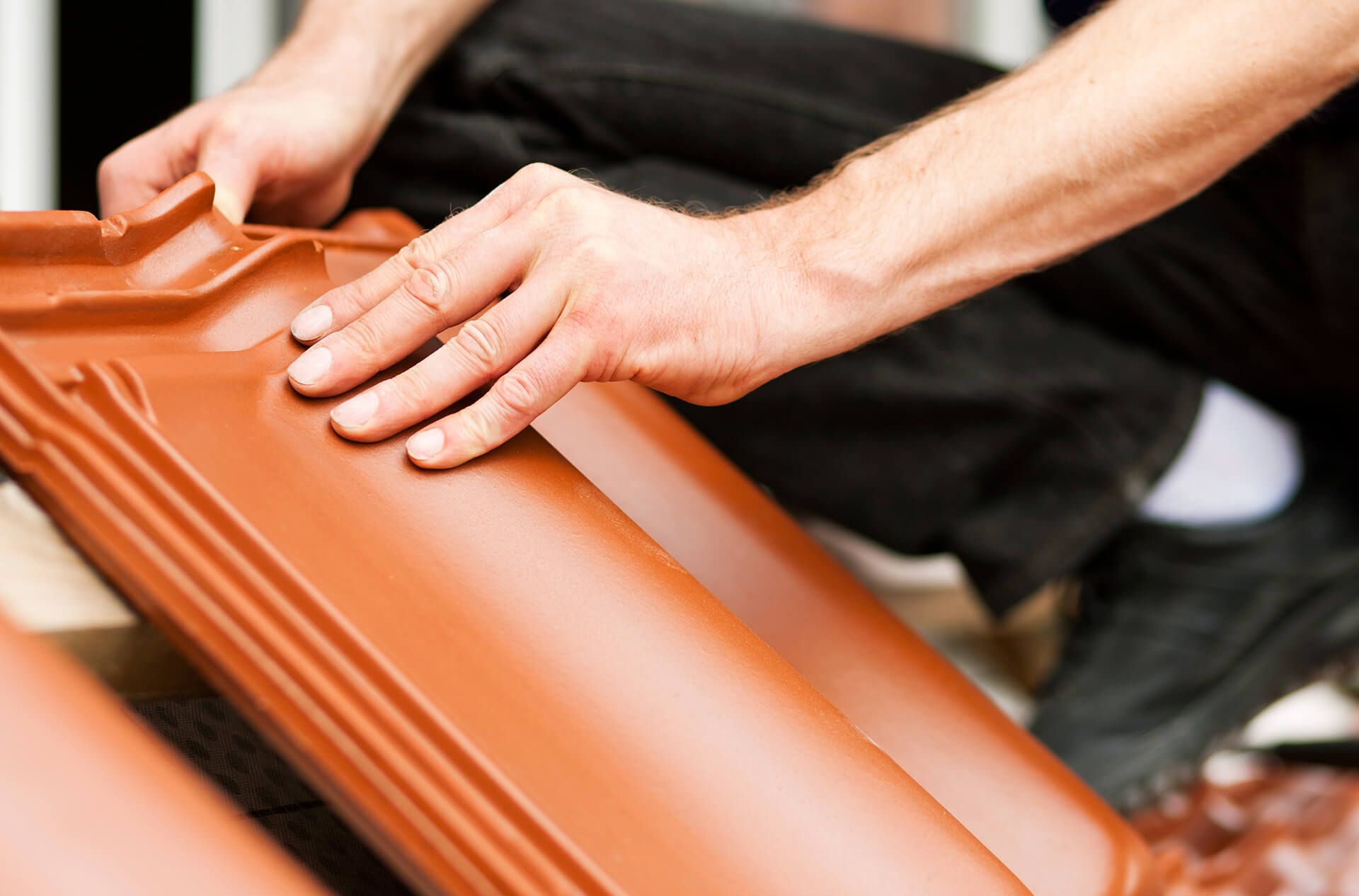 man holding a roof tile roofing